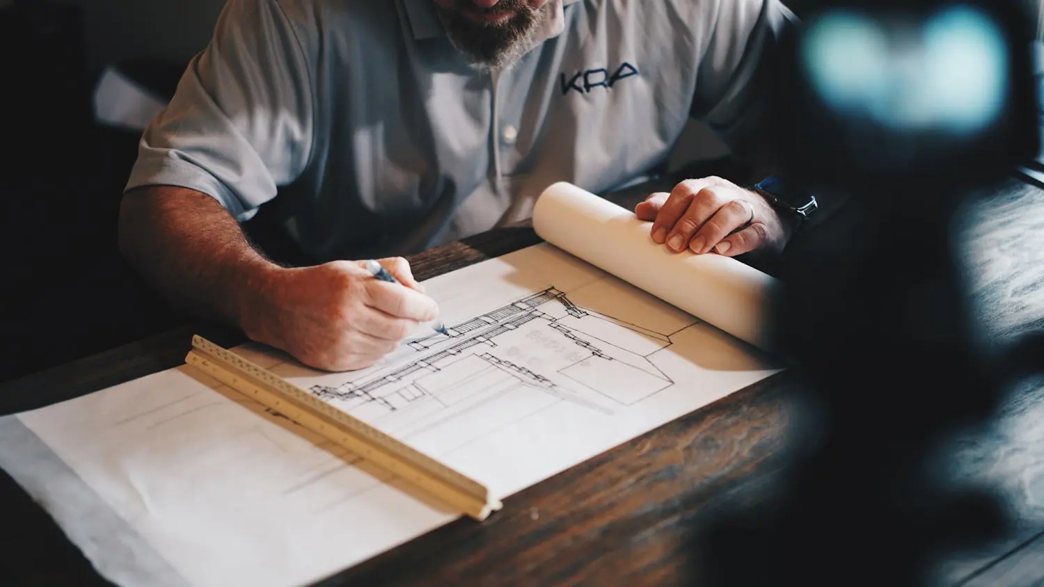Site supervisor reviewing building plans on a work table