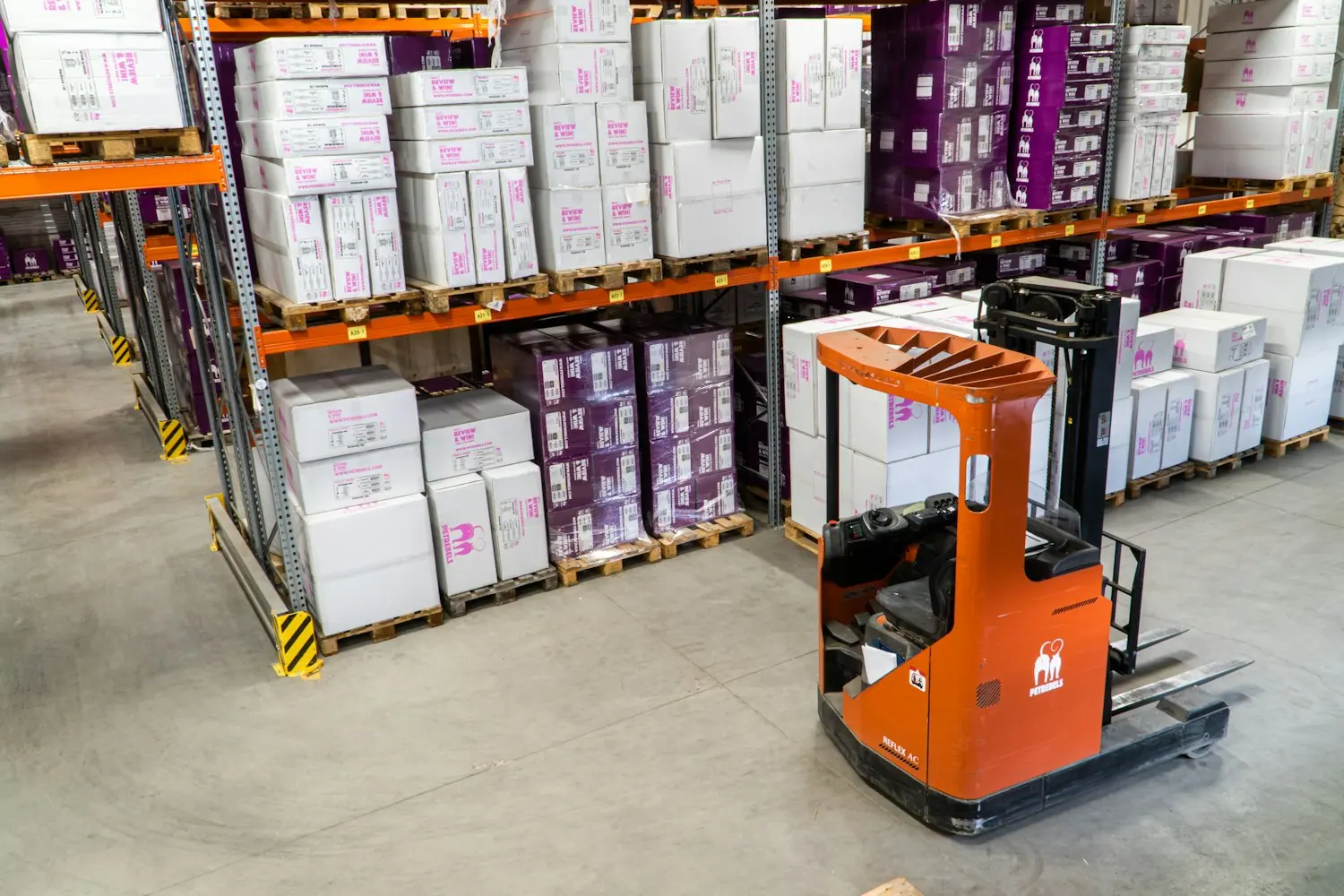 Warehouse interior with racking and a forklift